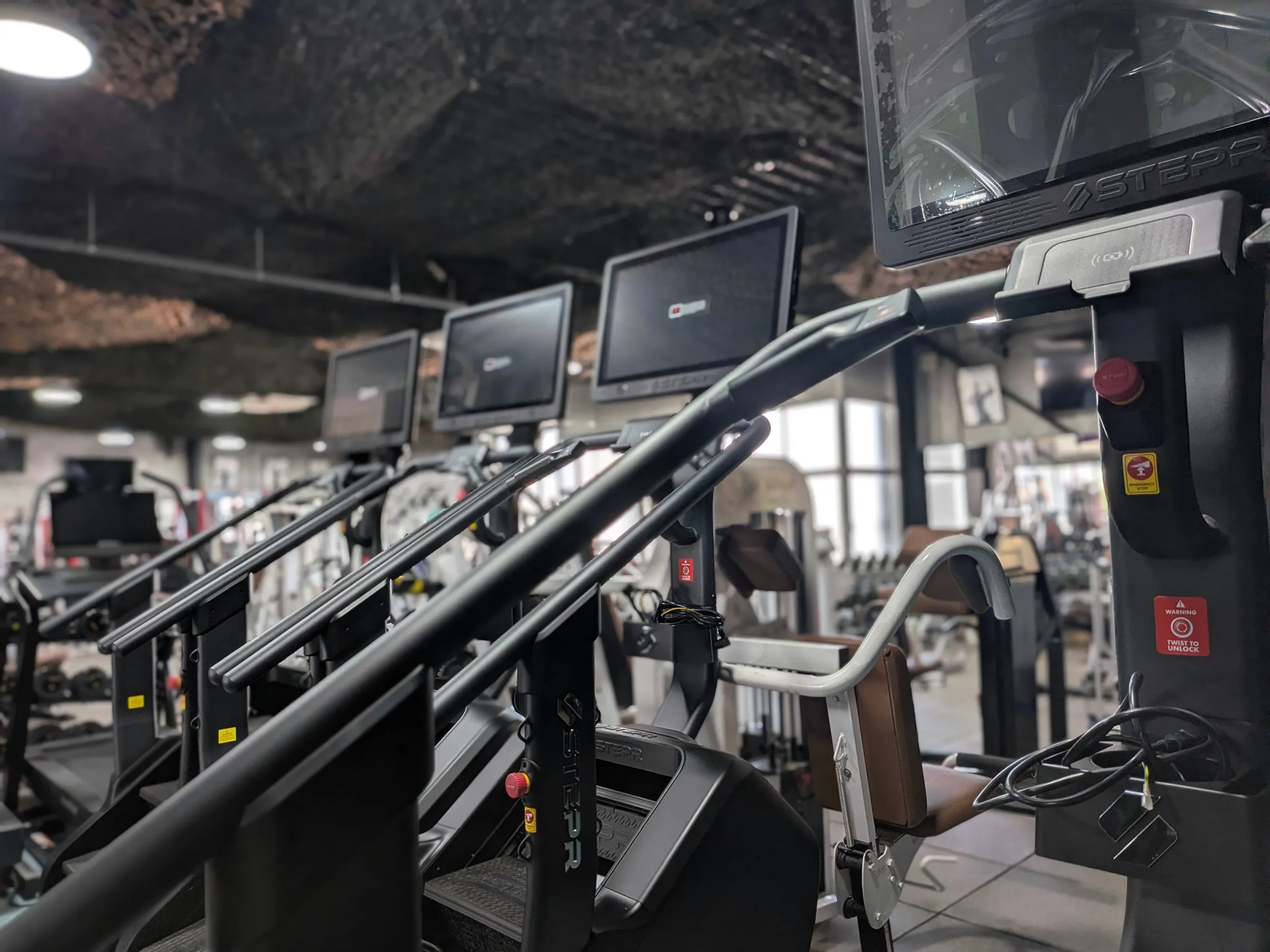 A row of STEPR Pro Plus revolving stair climbers at Iron Shogun